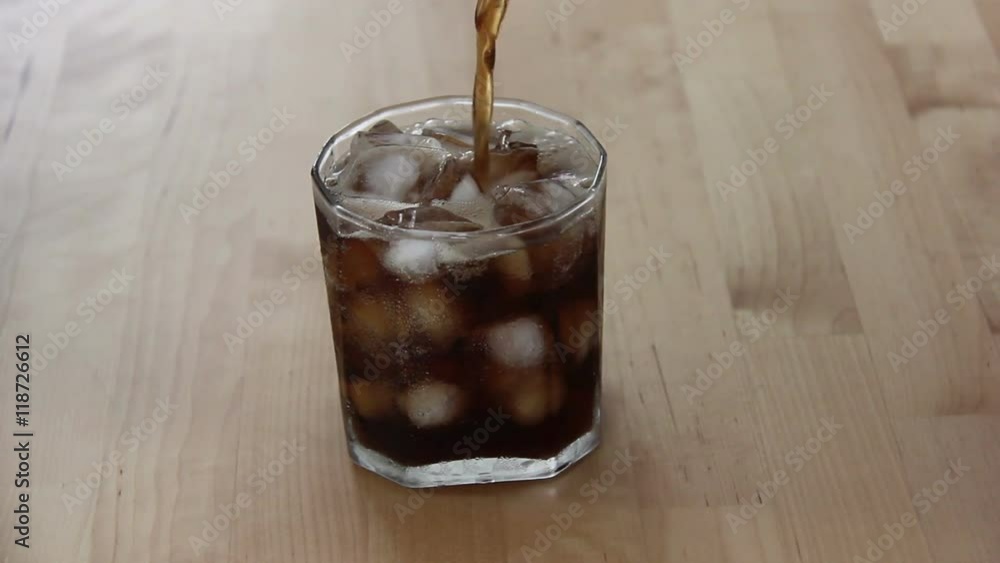 Pouring Cola In Full Of Ice In Glass Pouring Cola In Full Of Ice In Glass