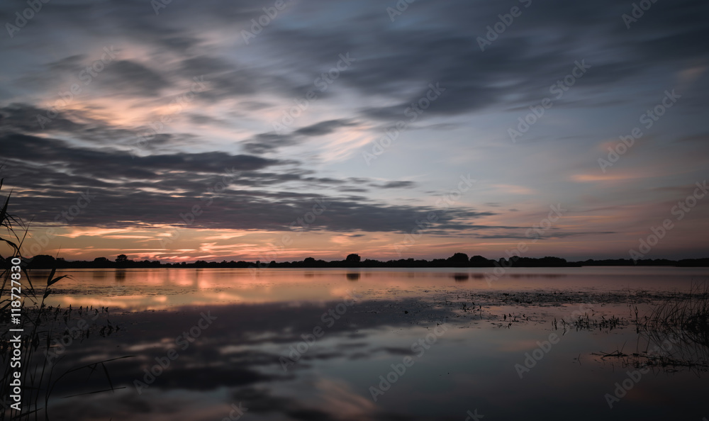 summer sunset on the lake after rain