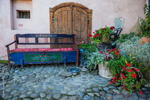 Wooden bench next to restaurant in Sighisoara town in Romania