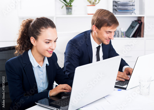 Man and woman coworkers working on computers