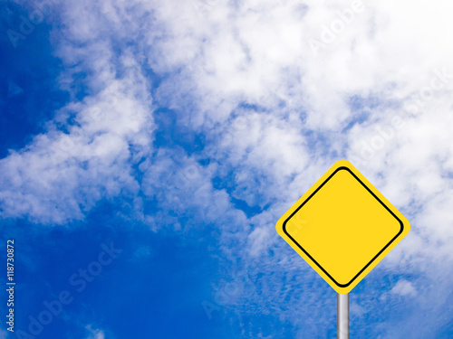 Blank yellow transportation sign on clear blue sky with white cl