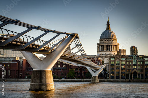 St. Paul's Cathedral and Millennium Bridge, officially known as the London Millennium Footbridge, across the river Thames photo