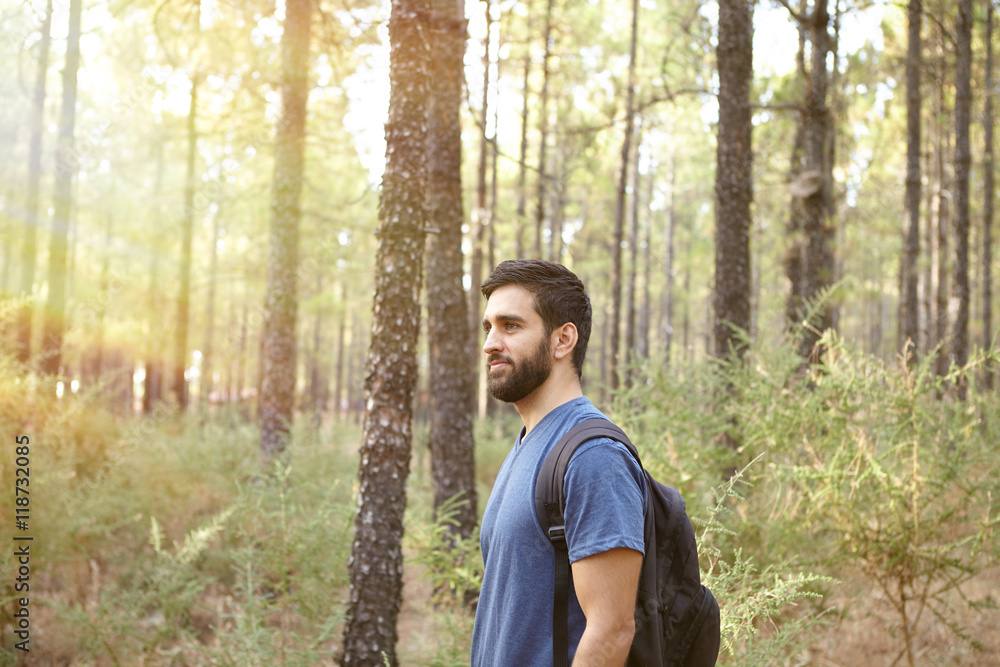 Young guy standing in the forest Young guy standing in the forest