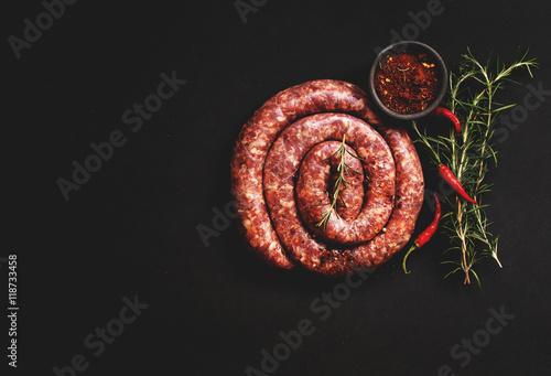 raw beef sausages on a cast-iron pan, selective focus
