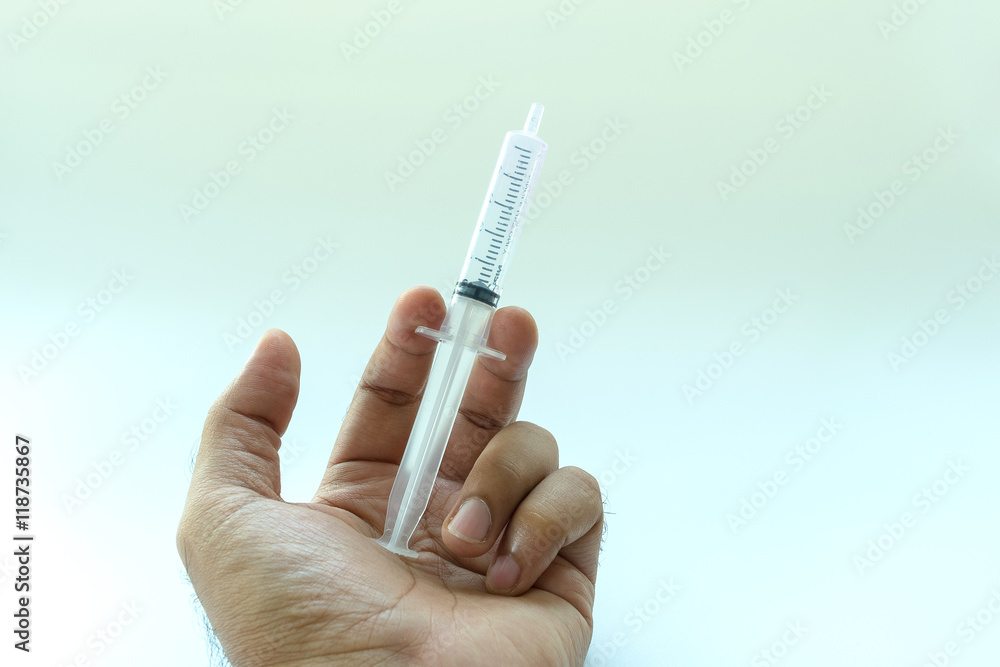 Doctor's hand holding a syringe, Liquid drug or narcotic , white background Doctor's hand holding a syringe, Liquid drug or narcotic , white background