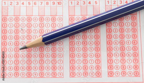 Student filling out answers to a test with a pencil.