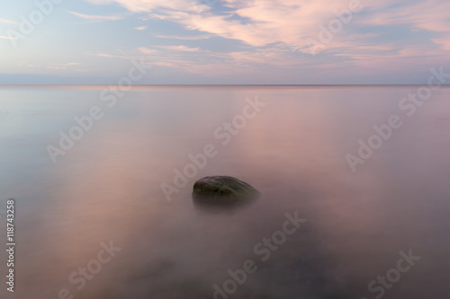 Long exporsure of a stone at sunset. Calm summer evening at the island of Gotland in the Baltic sea.