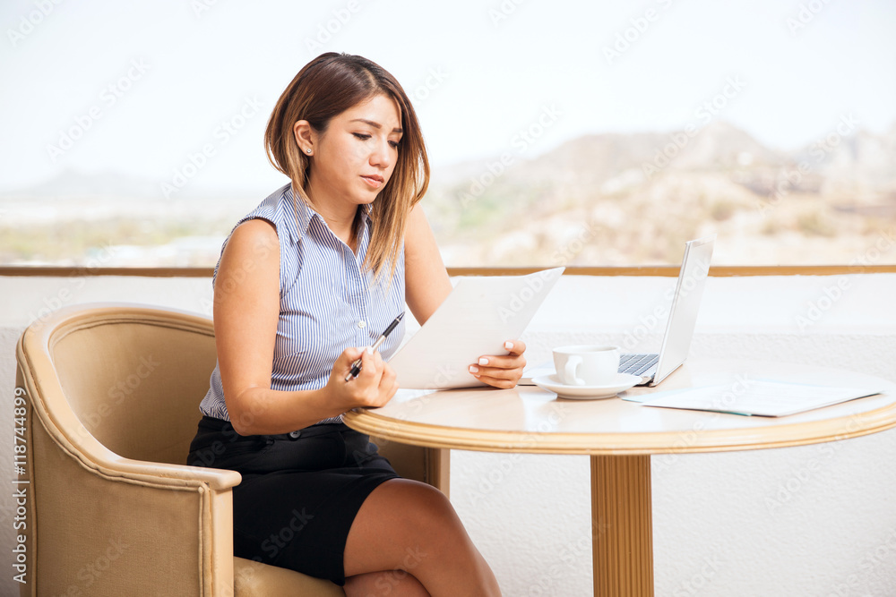 Pretty businesswoman reviewing documents Pretty businesswoman reviewing documents