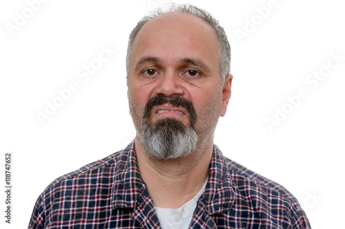 Disgusted man with beard makes face at camera