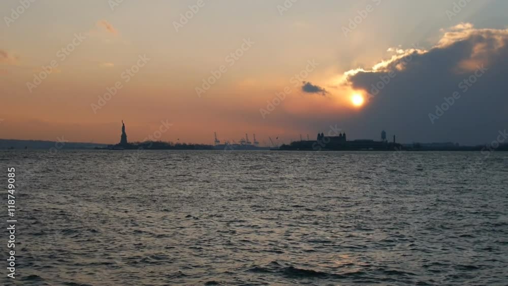 Clip of the Statue of Liberty at sunset with boat passing in front. Clip of the Statue of Liberty at sunset with boat passing in front.
