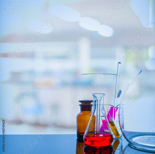 glassware with blur laboratory in background.