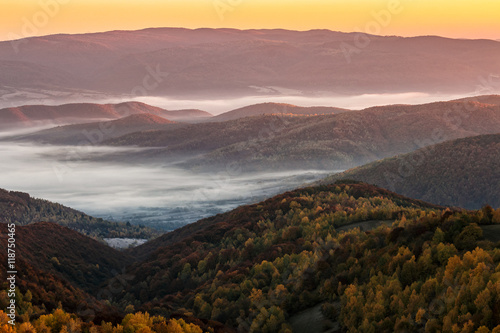 cold autumn morning fog on red hot sunrise in the Carpathian mountains © Pellinni