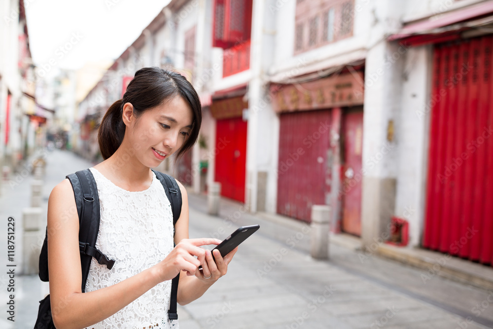 Woman using cellphone to search for wifi Woman using cellphone to search for wifi