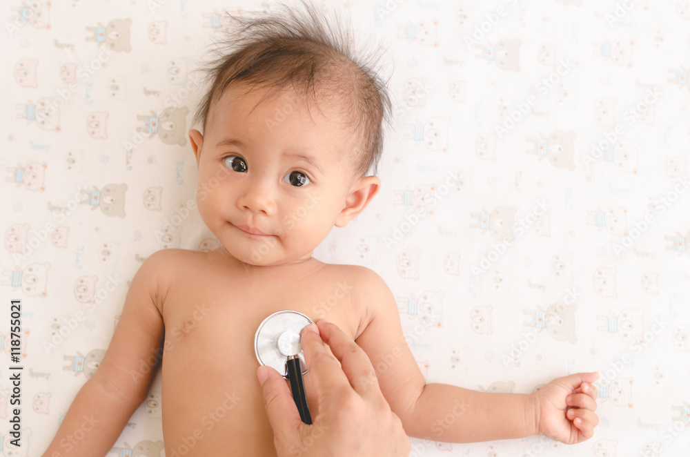 Close up Asian baby health check with stethoscope, health care m Close up Asian baby health check with stethoscope, health care m