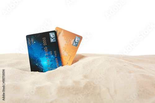 Credit cards in sand on whi...