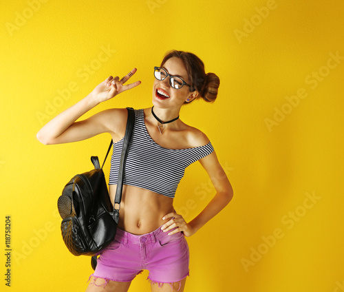 Beautiful girl on yellow ba...
