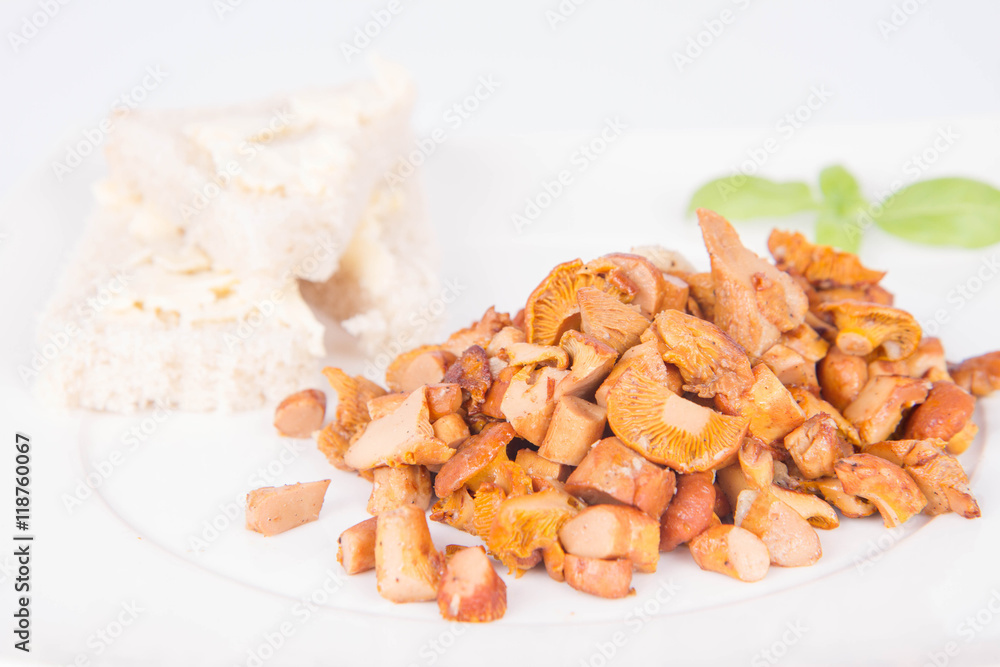 Sauteed chanterelle with garlic and some white bread on a plate decorated with basil Sauteed chanterelle with garlic and some white bread on a plate decorated with basil