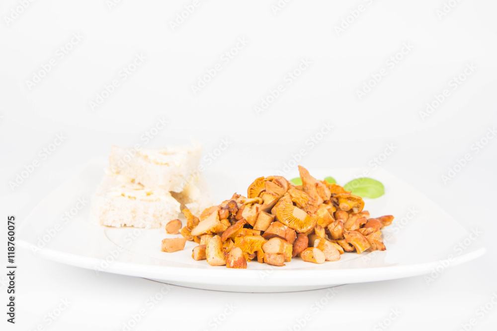 Sauteed chanterelle with garlic and some white bread on a plate decorated with basil Sauteed chanterelle with garlic and some white bread on a plate decorated with basil