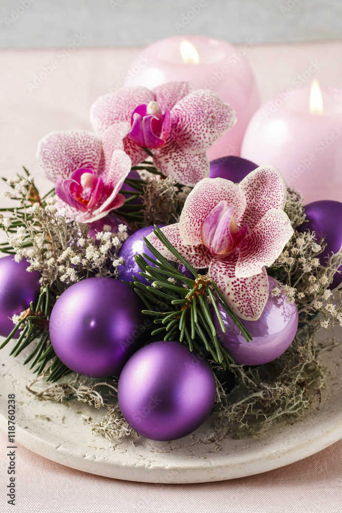 Woman making christmas decorations with violet balls, fir and or Woman making christmas decorations with violet balls, fir and or