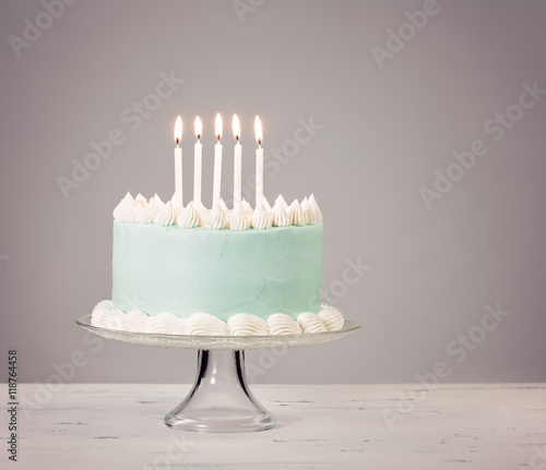 Blue Birthday Cake over grey Background.
