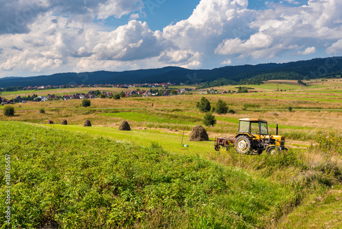 A view of harvest fields with tractor in Poland.