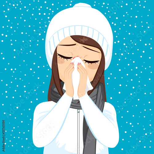 Young woman having flu blowing nose with white paper tissue on winter