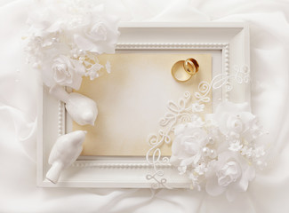 empty photo frame and wedding rings - wedding background