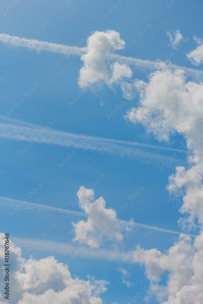 Blue sky with white clouds and contrails Blue sky with white clouds and contrails