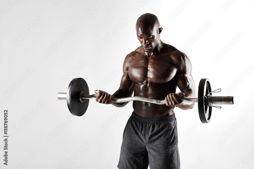 Young bodybuilder training over grey background Young bodybuilder training over grey background