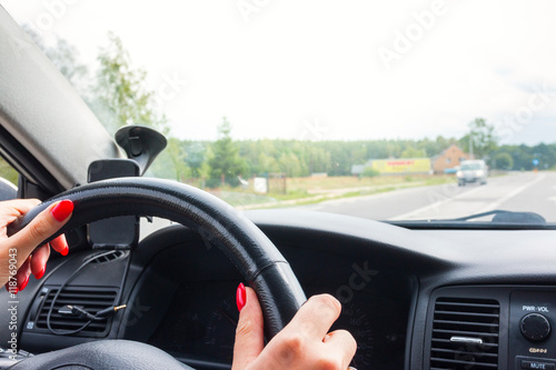 Woman holding steering wheel, drives the car