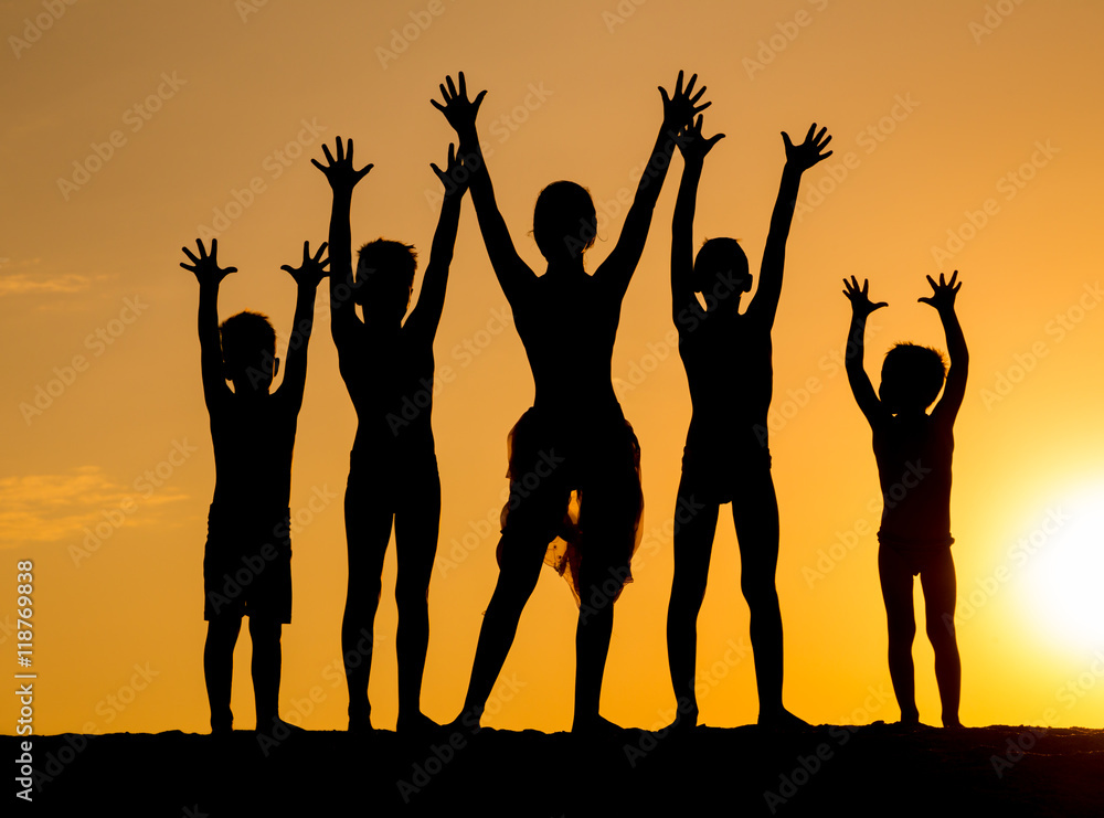 silhouette of kids against sunset