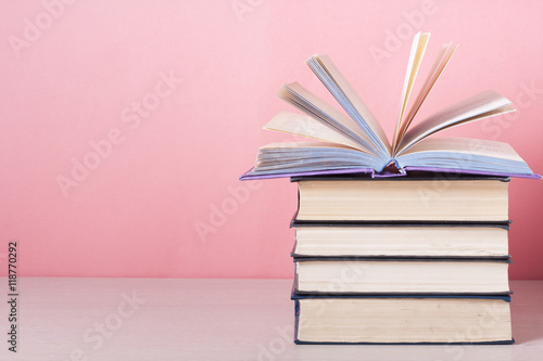 Open book, hardback books on wooden table. Education background. Back to school. Copy space for text.