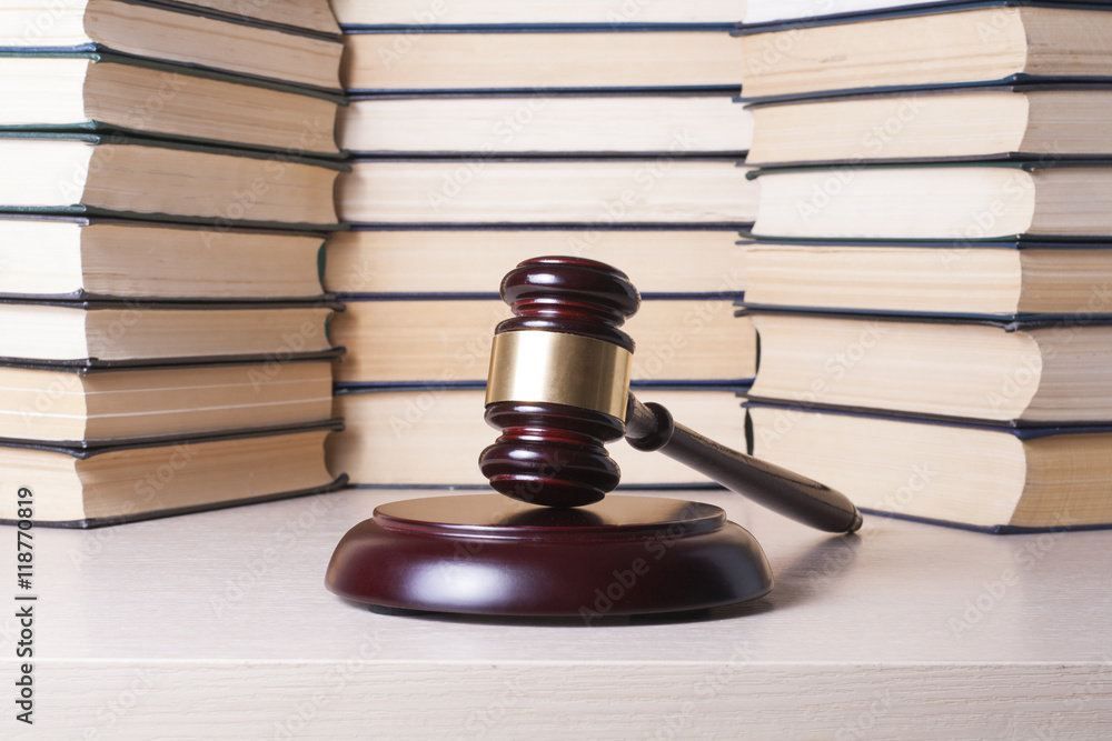 Law concept - Book with wooden judges gavel on table in a courtroom or enforcement office. Law concept - Book with wooden judges gavel on table in a courtroom or enforcement office.