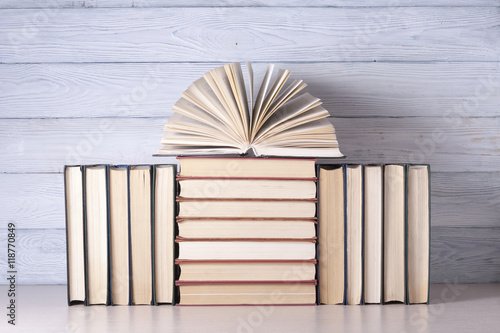 Open book, hardback books on wooden table. Education background. Back to school. Copy space for text.