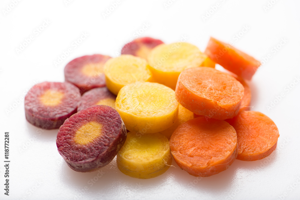 chopped carrots in different colors, isolated on white, close up, horizontal chopped carrots in different colors, isolated on white, close up, horizontal