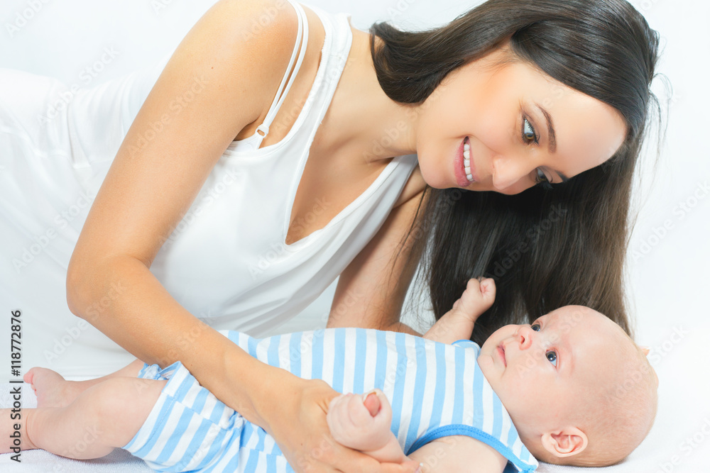 Happy mother holding a baby boy at white background Happy mother holding a baby boy at white background