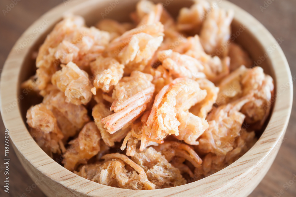 Fried shrimp chins snack in wooden bowl Fried shrimp chins snack in wooden bowl
