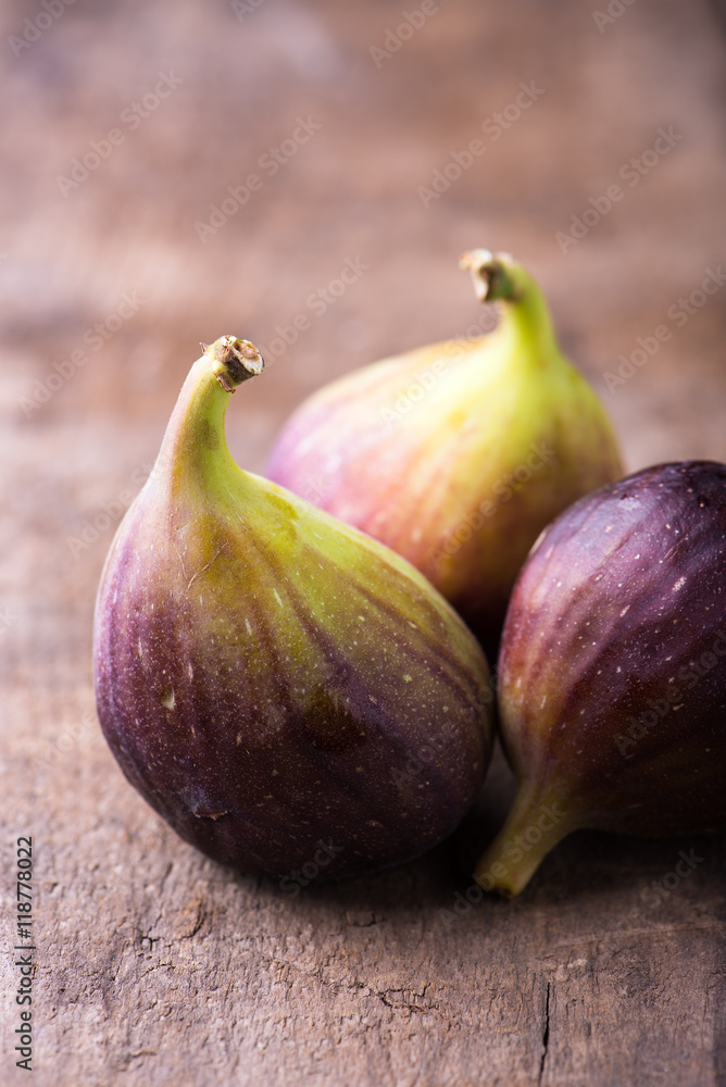 close up of organic, fresh figs isolated on rustic wood background, vertical with copy space close up of organic, fresh figs isolated on rustic wood background, vertical with copy space