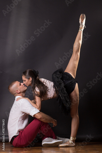 Intimate young woman ballerina dancer kissing boy man
