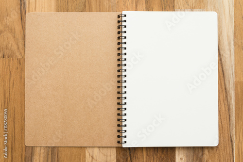 Blank empty notepad on wooden table background - Business and education concept.