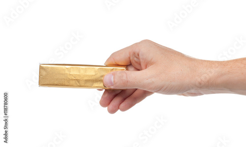 Hand holds tasty chocolate. Isolated on a white background.