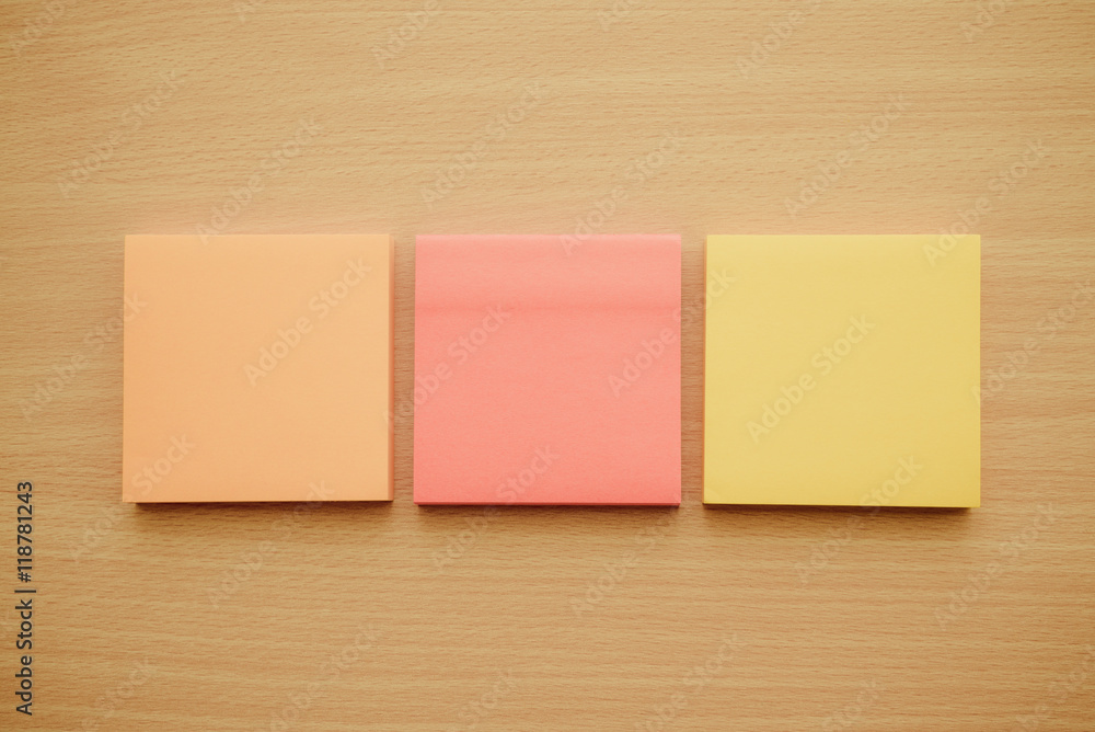 Color block of paper notes on wooden table background. Color block of paper notes on wooden table background.