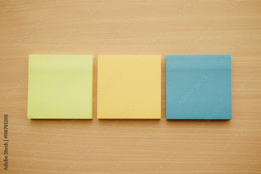 Color block of paper notes on wooden table background. Color block of paper notes on wooden table background.