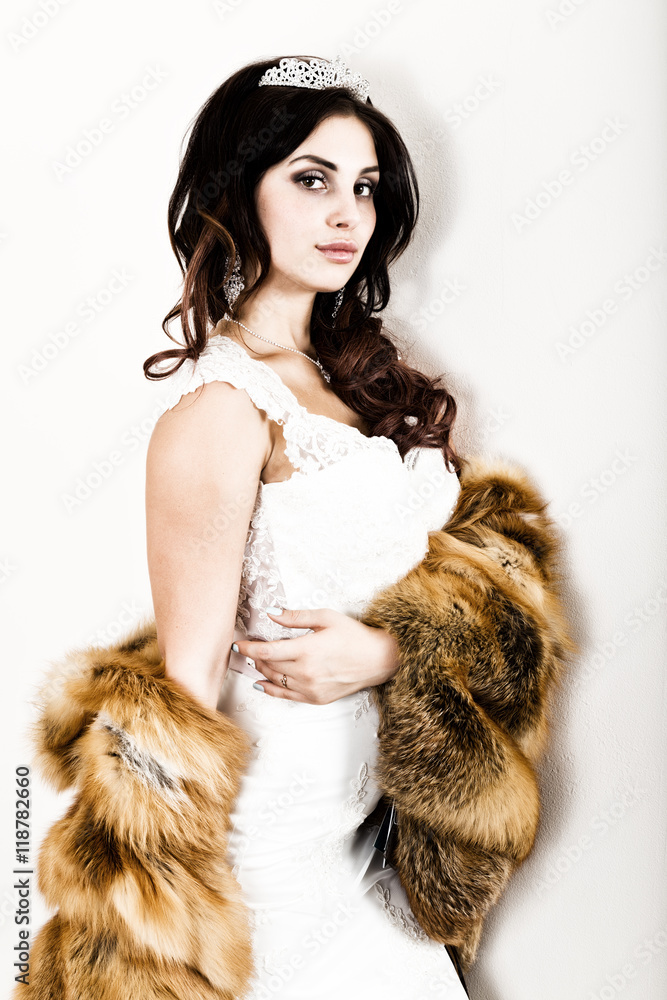 close-up portrait of young beautiful bride in a wedding dress with a wedding makeup and hairstyle. young bride in a fur coat from a red fur close-up portrait of young beautiful bride in a wedding dress with a wedding makeup and hairstyle. young bride in a fur coat from a red fur