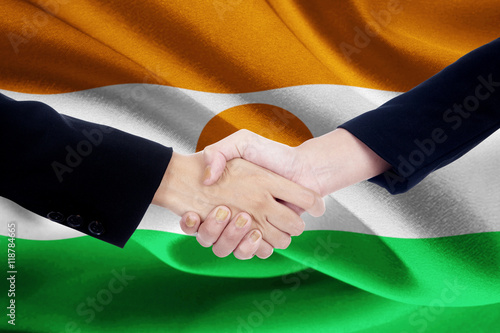 Friendship handshake with flag of Niger