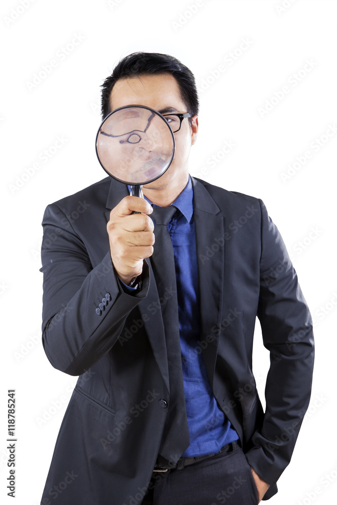 Male worker with magnifier in studio Male worker with magnifier in studio