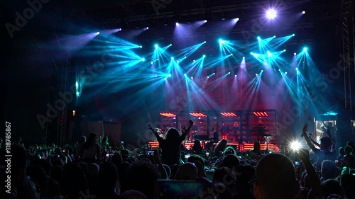 silhouettes of concert crowd in front of stage