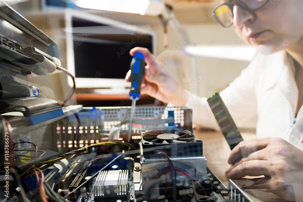 Computer Technician repairing Hardware throw the window image Computer Technician repairing Hardware throw the window image