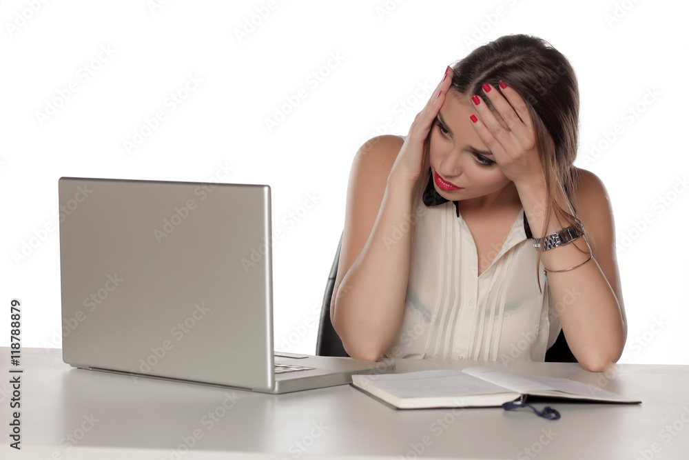 Young and worried beautiful woman with laptop and notebook Young and worried beautiful woman with laptop and notebook