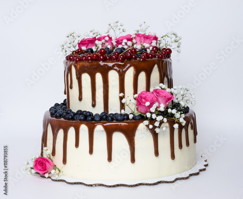 two layered color drip wedding cake with bilberries, red currant